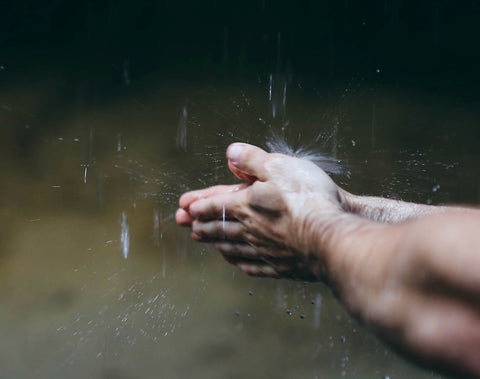 Men's hands lathering with natural soap