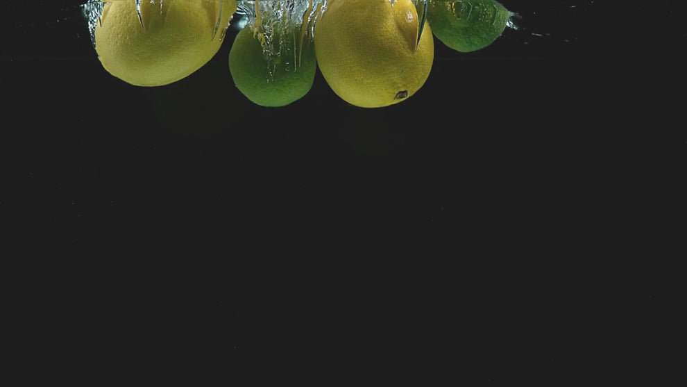 lemons and limes falling into water
