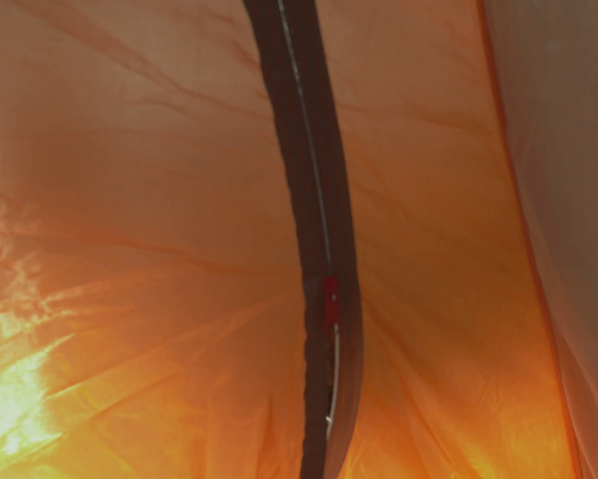 Camper opening tent in woods